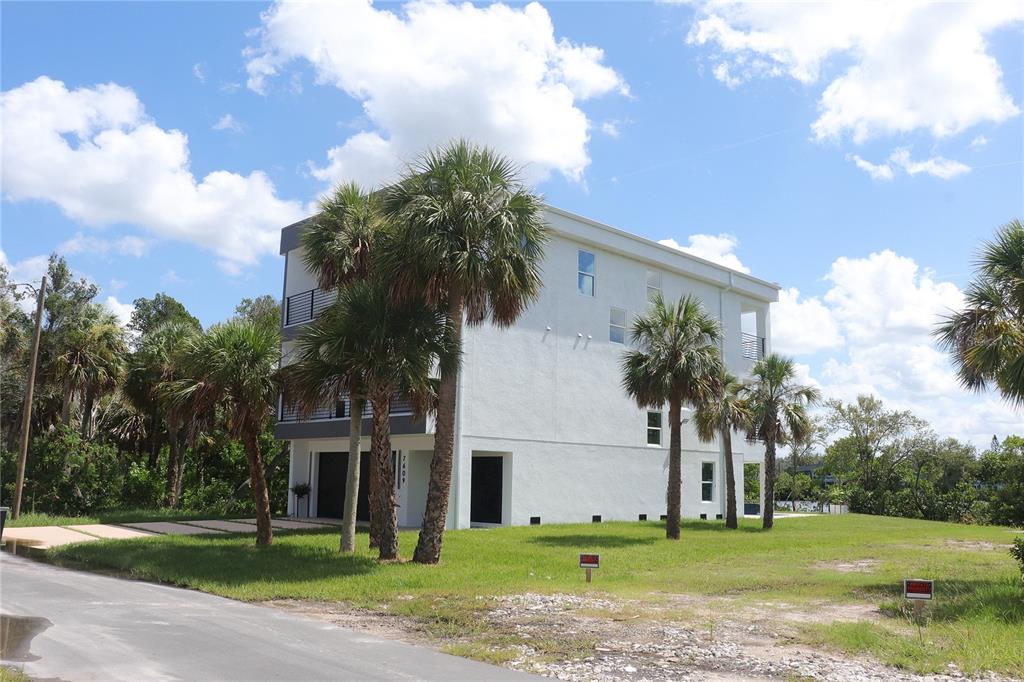 7609 Deedra Circle Port Richey, FL 34668 - Photo 8 of 63 a front view of a house with a yard