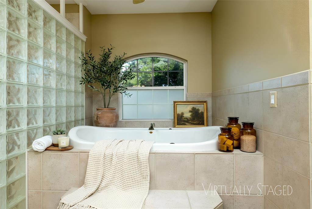 270 Stone Mountain Road Cresson, TX 76035 - Photo 18 of 40 a bedroom with a bed and a chandelier