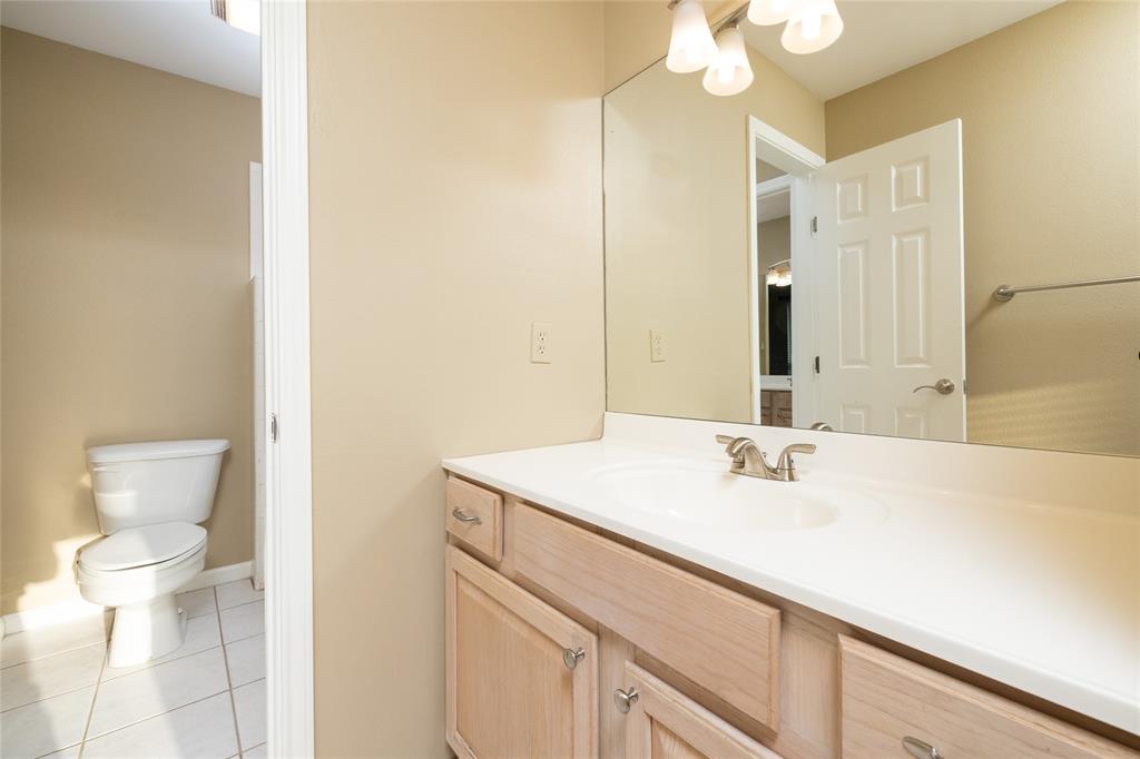 270 Stone Mountain Road Cresson, TX 76035 - Photo 25 of 40 a bathroom with a sink a toilet and a mirror