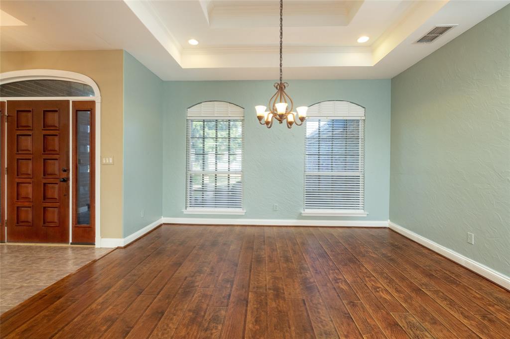 270 Stone Mountain Road Cresson, TX 76035 - Photo 8 of 40 an empty room with wooden floor chandelier and windows
