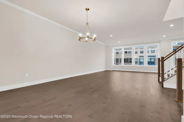 a view of a livingroom with wooden floor and a ceiling fan