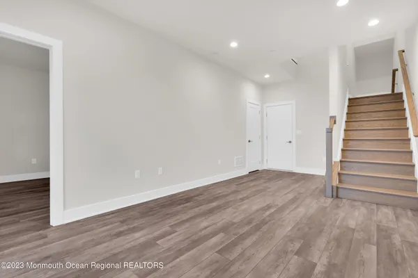 a view of wooden floor and entryway in a room