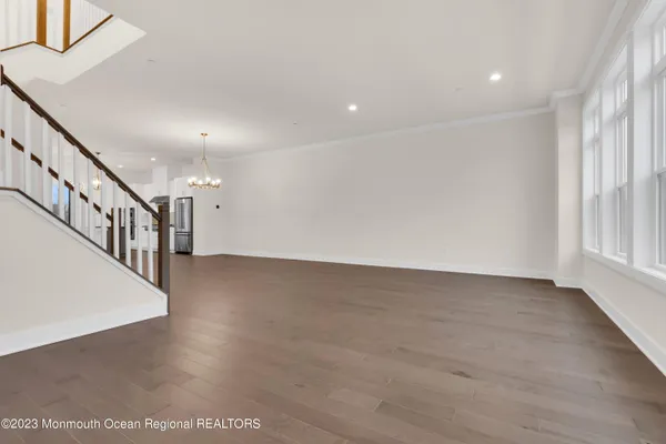 a view of room and hall with wooden floor