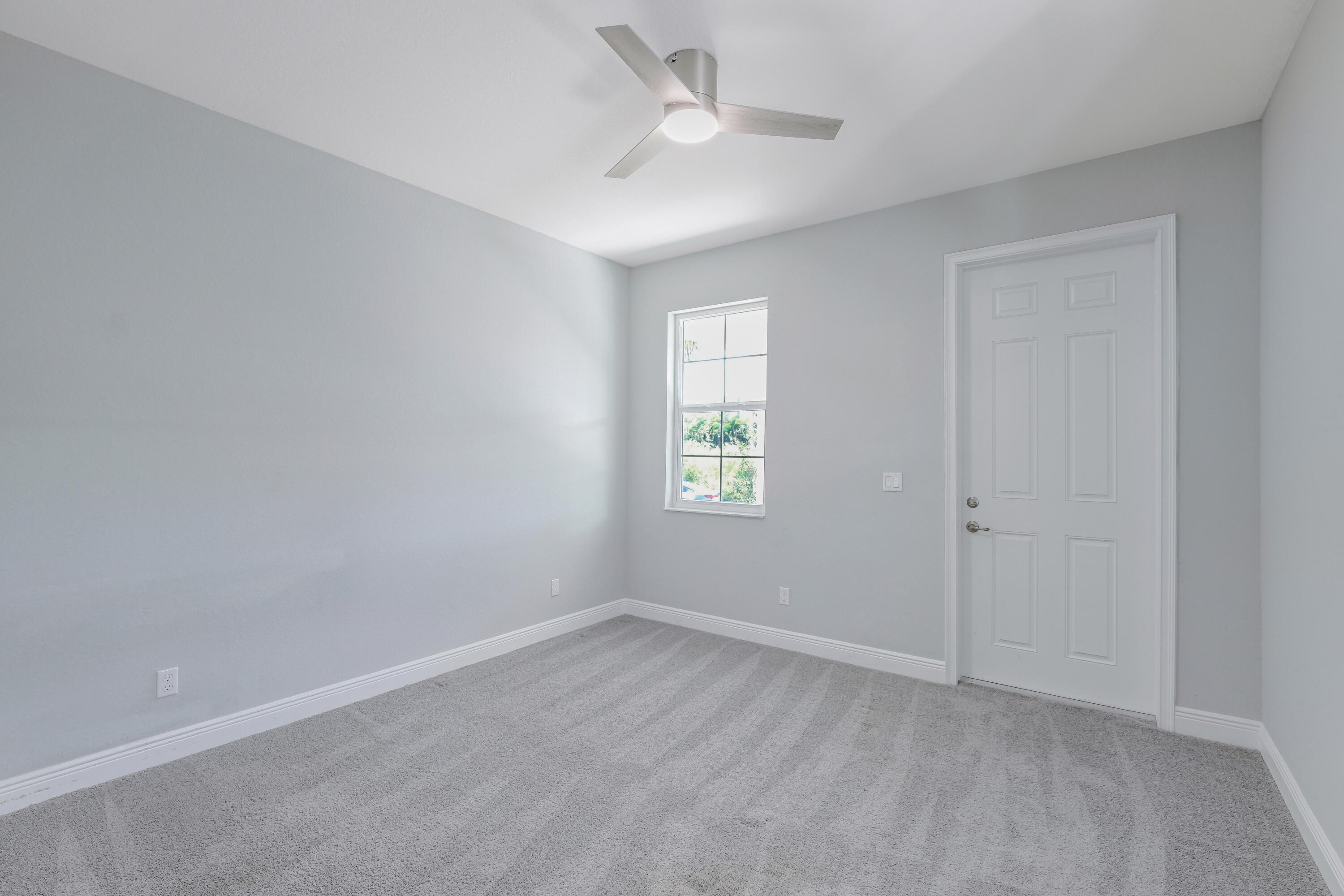 4982 Southeast Railway Avenue Stuart, FL 34997 - Photo 11 of 36 an empty room with a window and ceiling fan
