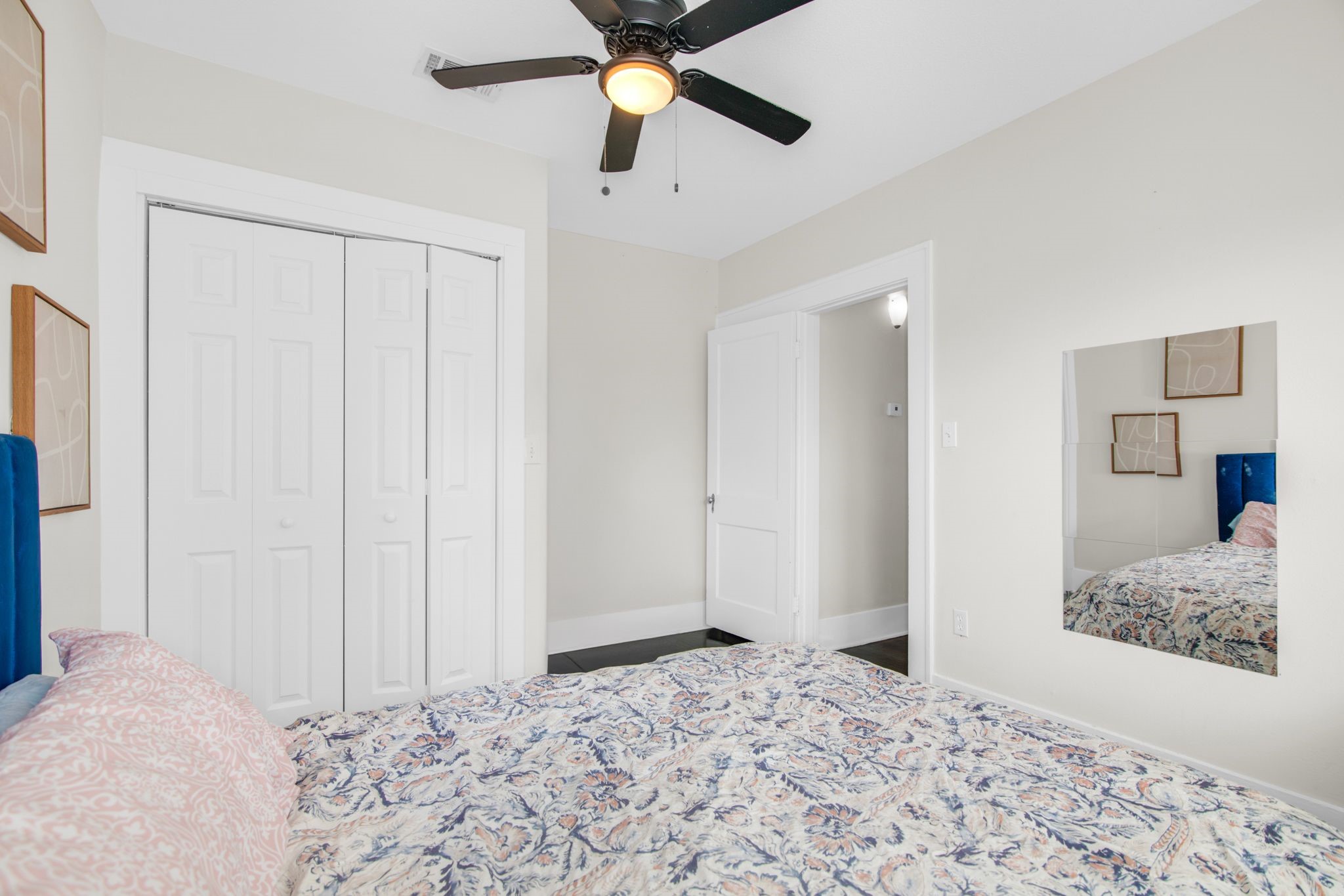 1432 Godwin Street Houston, TX 77023 - Photo 13 of 40 a bedroom with a bed and a chandelier fan
