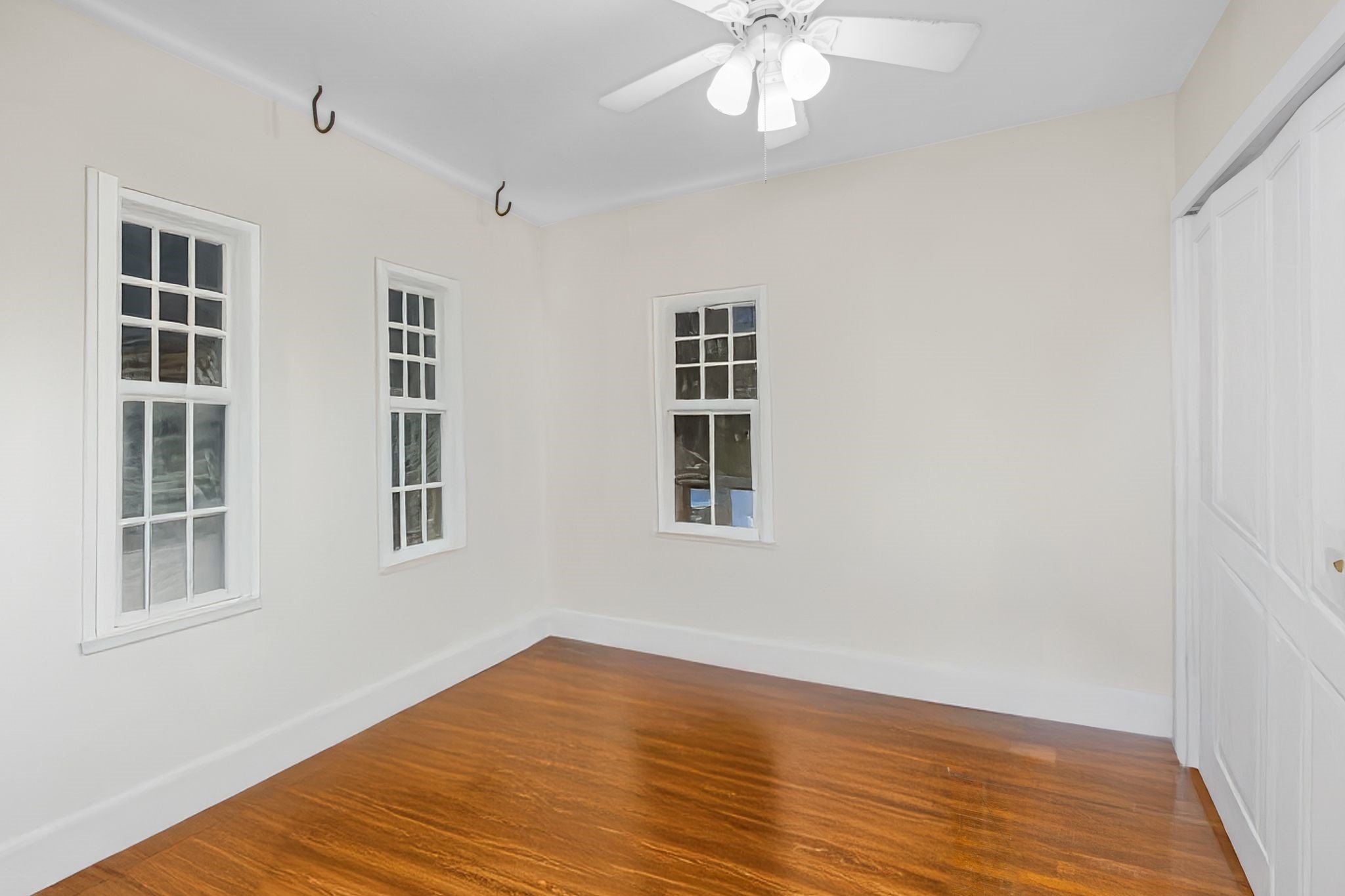 1432 Godwin Street Houston, TX 77023 - Photo 27 of 40 a view of an empty room with wooden floor and a window