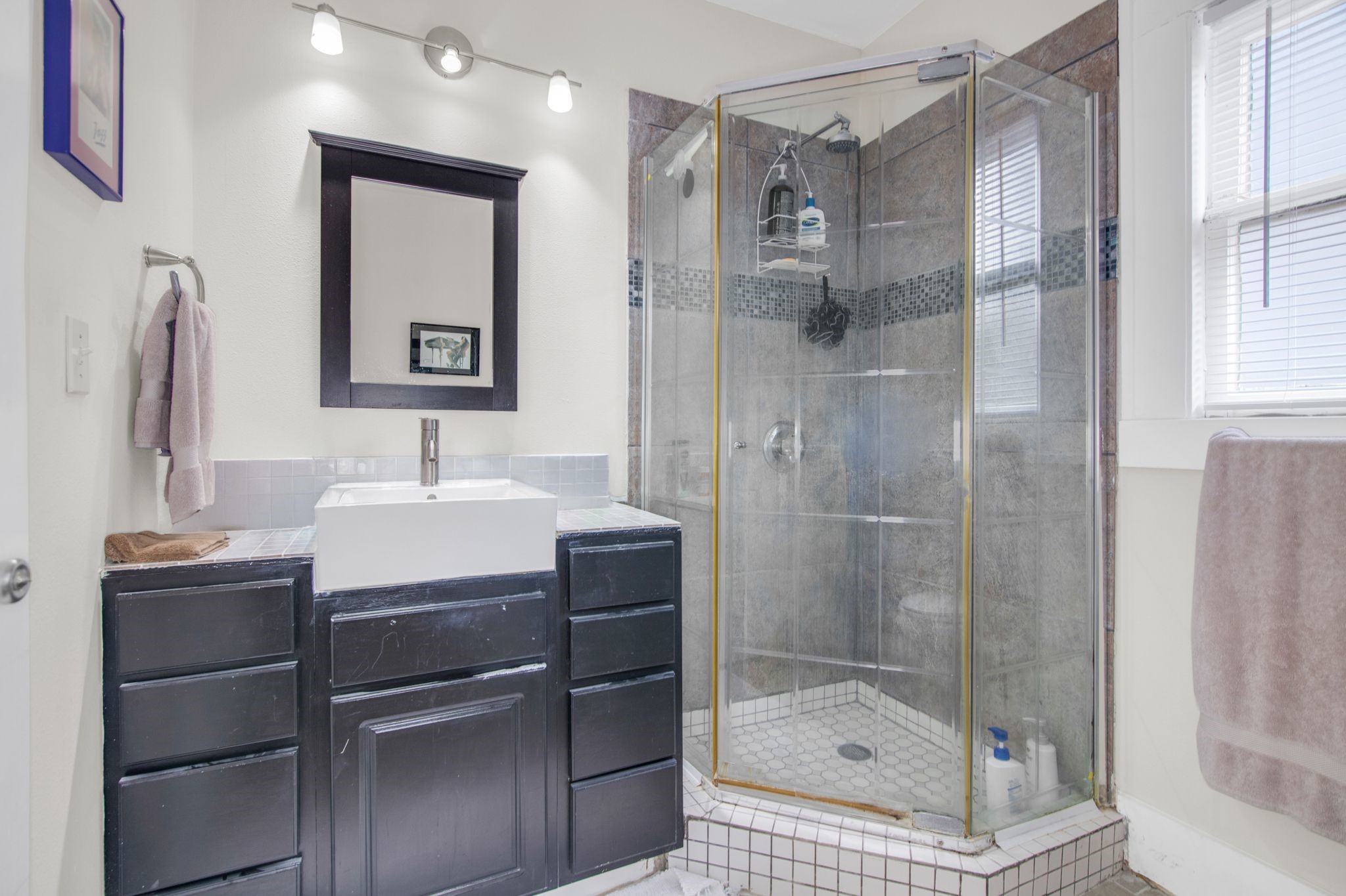 1432 Godwin Street Houston, TX 77023 - Photo 28 of 40 a bathroom with a shower sink and mirror