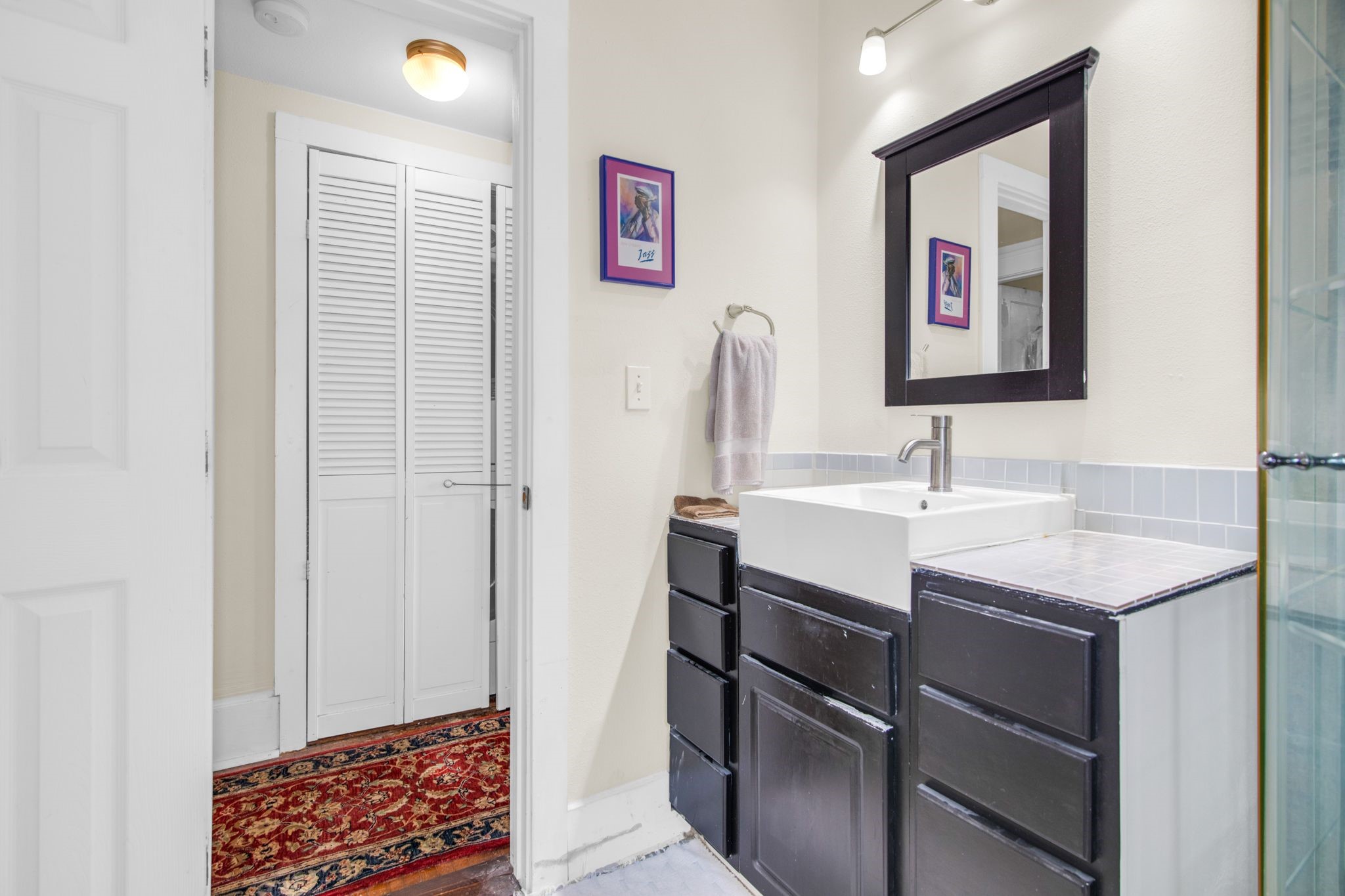 1432 Godwin Street Houston, TX 77023 - Photo 29 of 40 a bathroom with a sink a mirror and a window