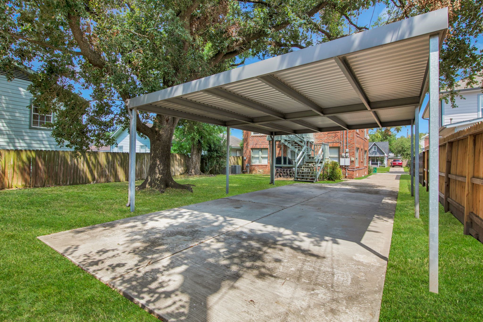 1432 Godwin Street Houston, TX 77023 - Photo 37 of 40 a view of a backyard with table and chairs under an umbrella