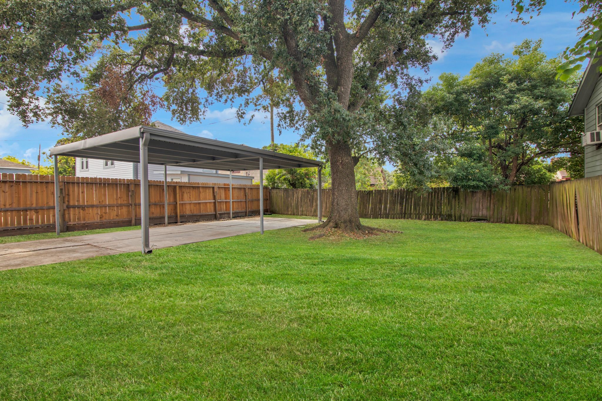 1432 Godwin Street Houston, TX 77023 - Photo 40 of 40 a view of a backyard with large trees and wooden fence