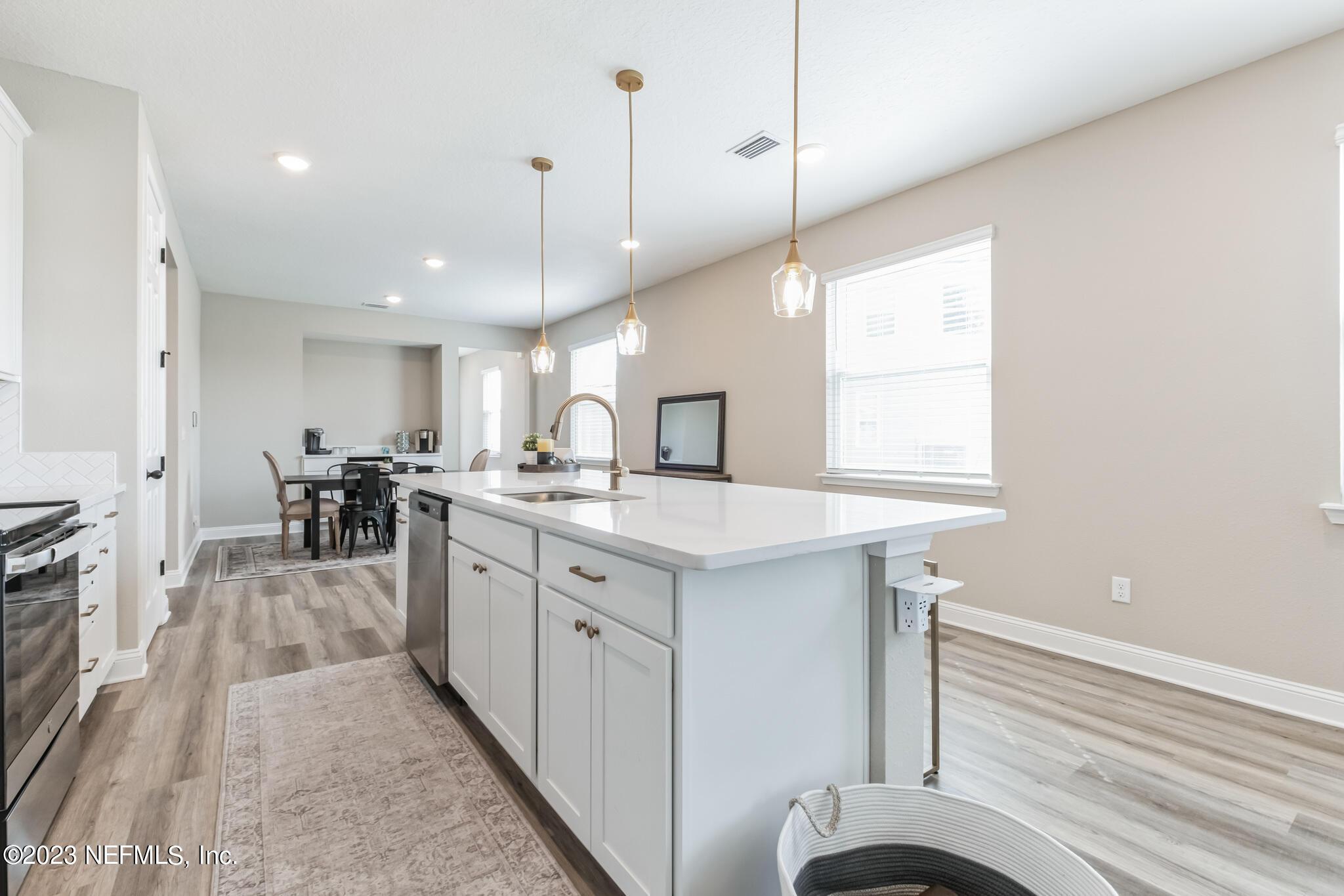 7062 Red Timber Road Jacksonville, FL 32244 - Photo 15 of 31 a kitchen with stainless steel appliances granite countertop a sink a stove and a wooden floors
