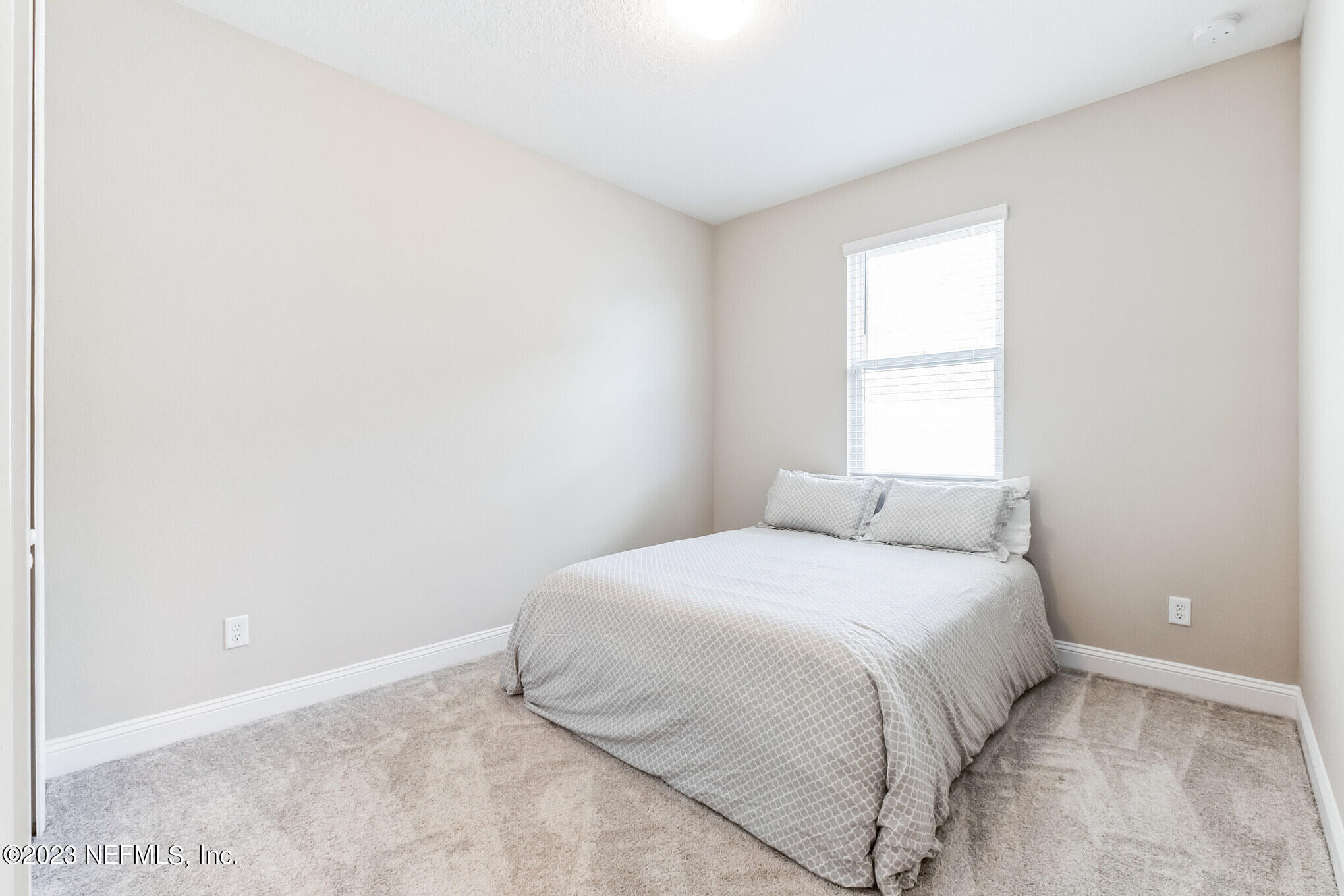 7062 Red Timber Road Jacksonville, FL 32244 - Photo 23 of 31 a bedroom with a bed and a window