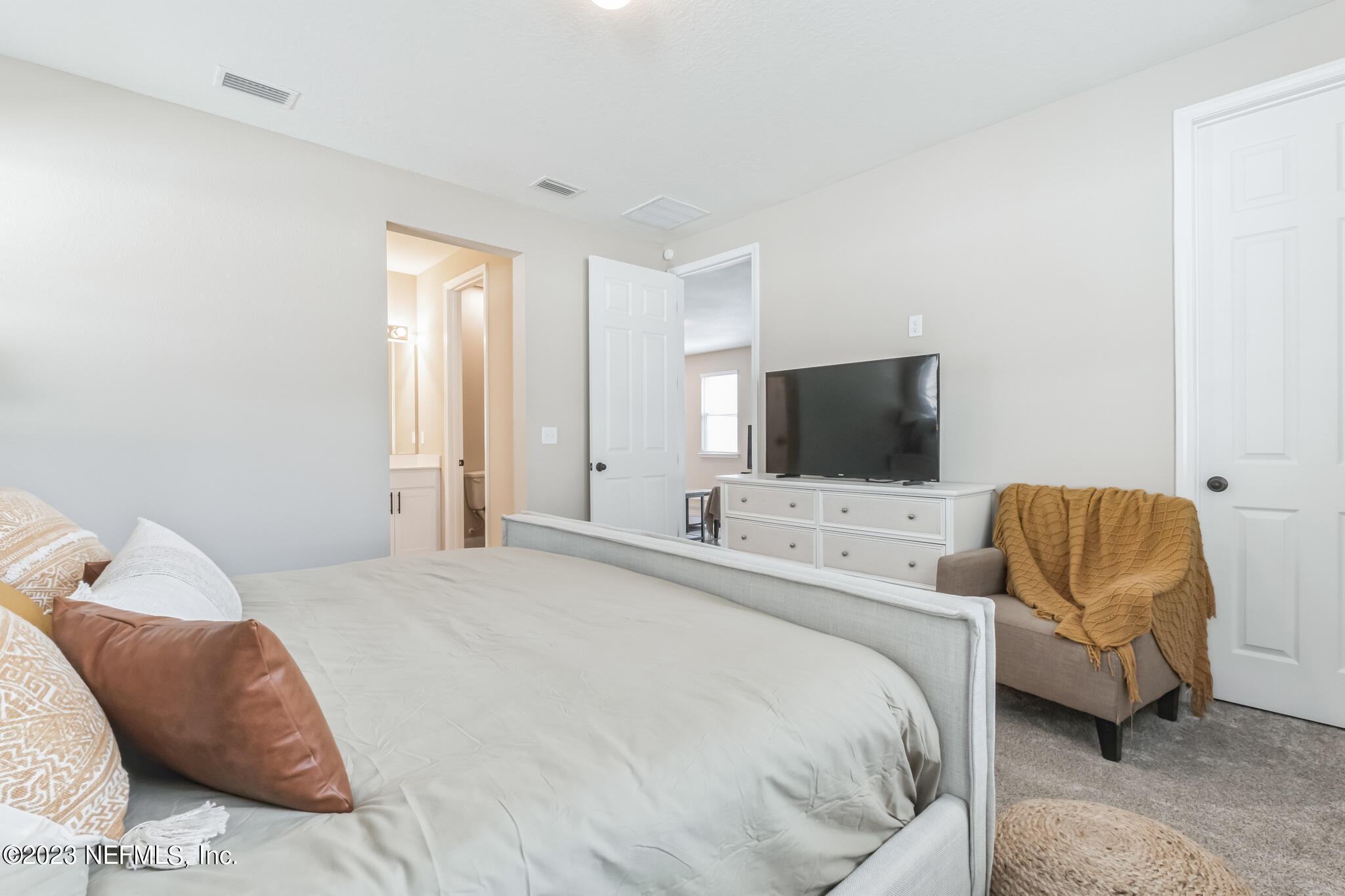 7062 Red Timber Road Jacksonville, FL 32244 - Photo 26 of 31 a bedroom with a bed and a flat screen tv