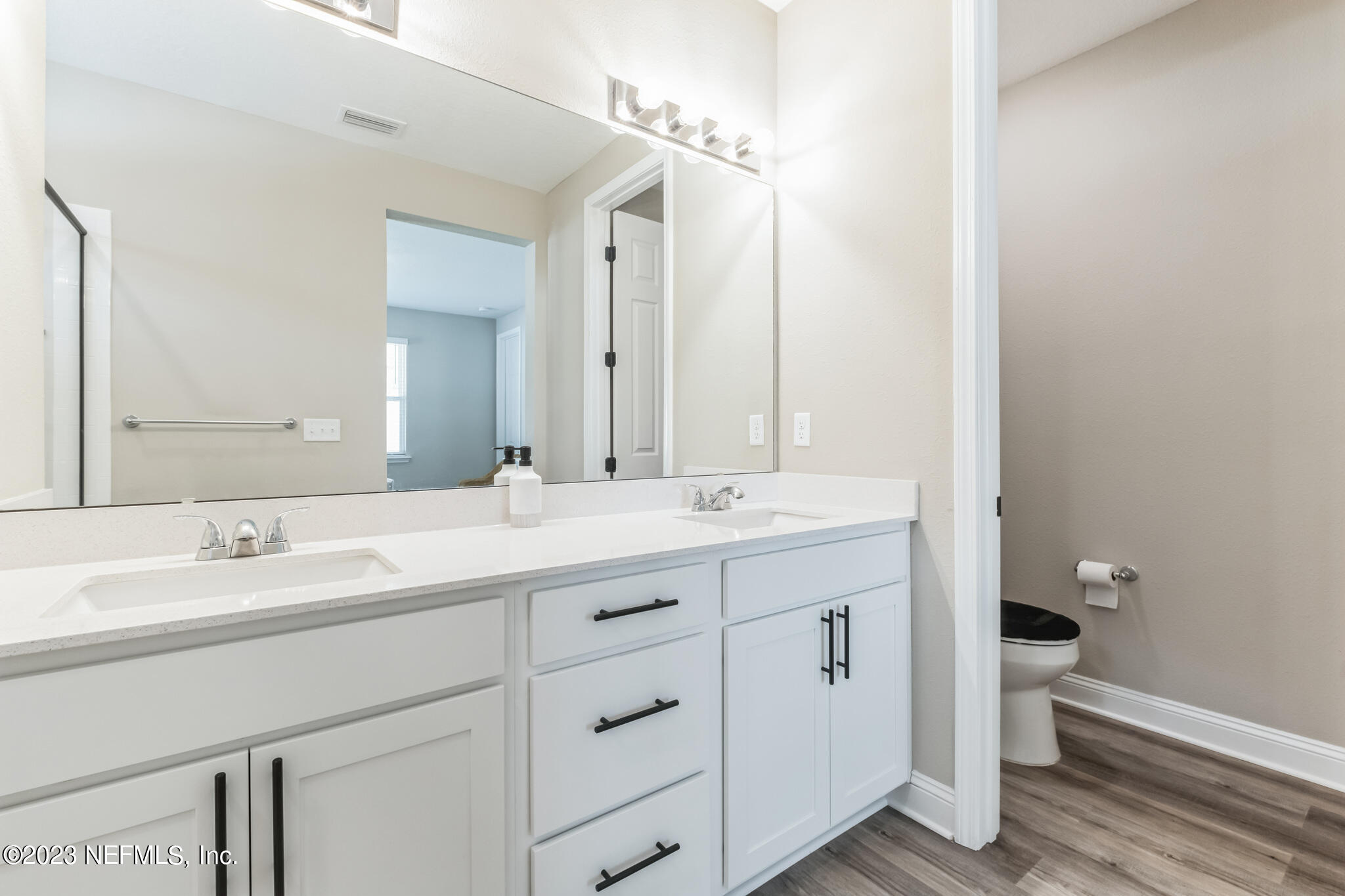 7062 Red Timber Road Jacksonville, FL 32244 - Photo 28 of 31 a bathroom with a double vanity sink and mirror