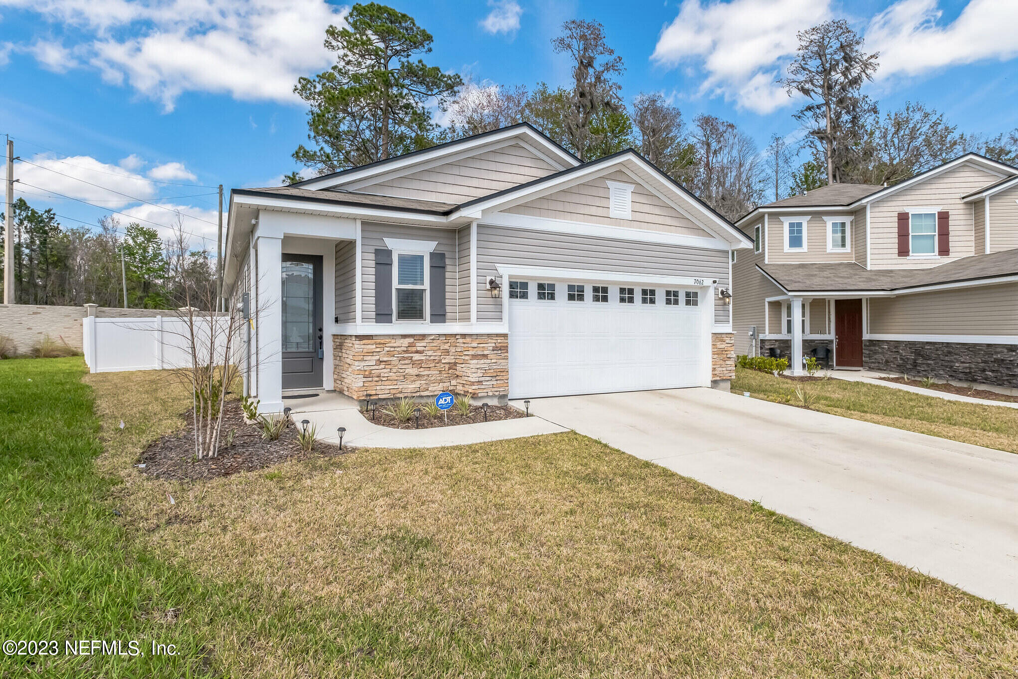 7062 Red Timber Road Jacksonville, FL 32244 - Photo 3 of 31 a view of a white house with a big yard and large tree