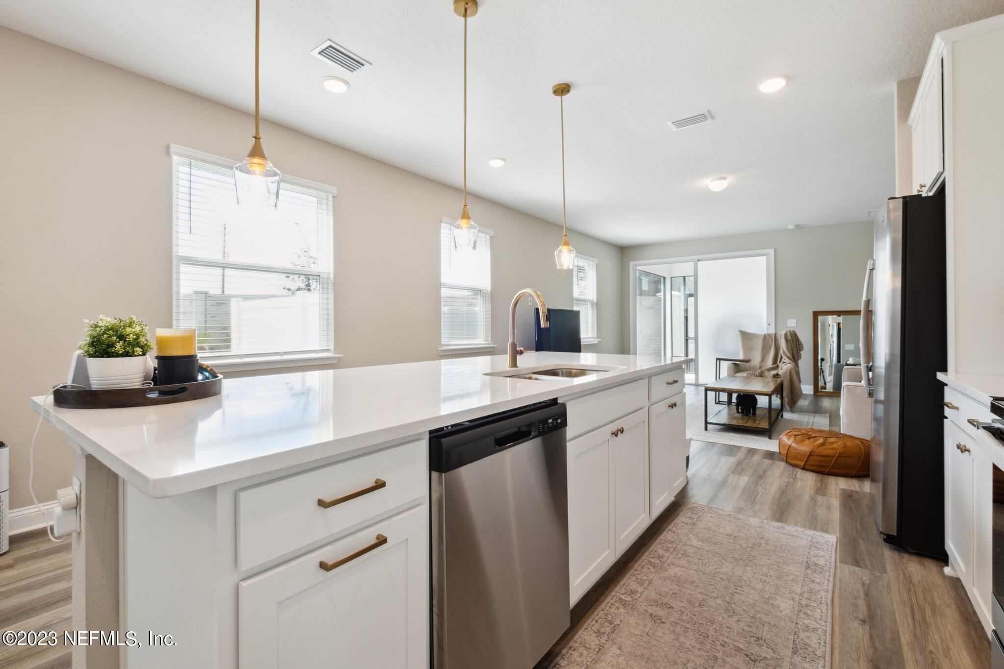 7062 Red Timber Road Jacksonville, FL 32244 - Photo 6 of 31 a kitchen with a sink center island cabinets and stainless steel appliances