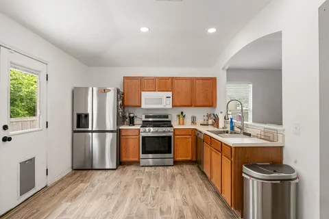 a kitchen with stainless steel appliances granite countertop a stove and a sink