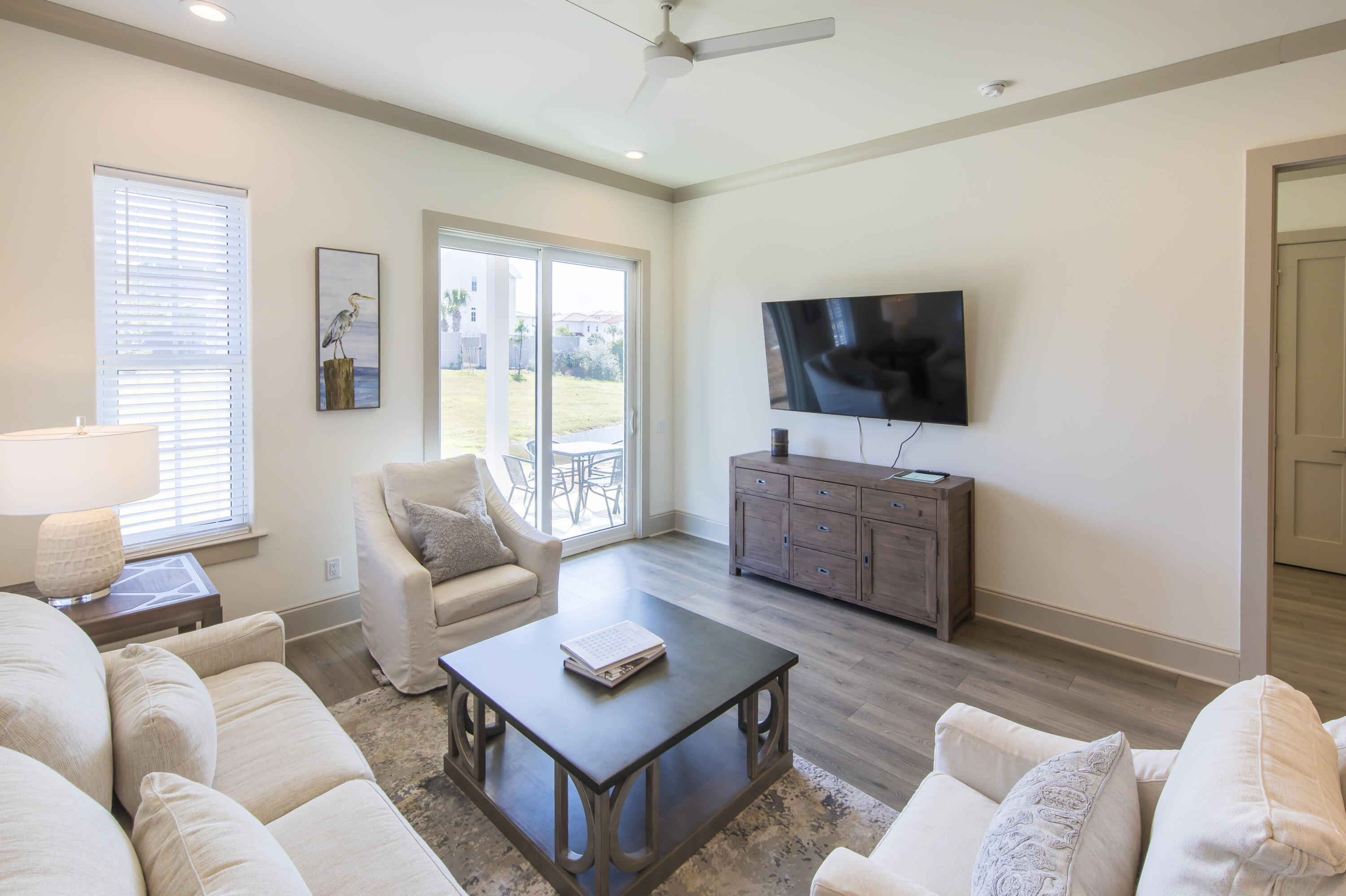70 Marthas Lane, Unit 1201 Santa Rosa Beach, FL 32459 - Photo 5 of 28 a living room with furniture a flat screen tv and a large window