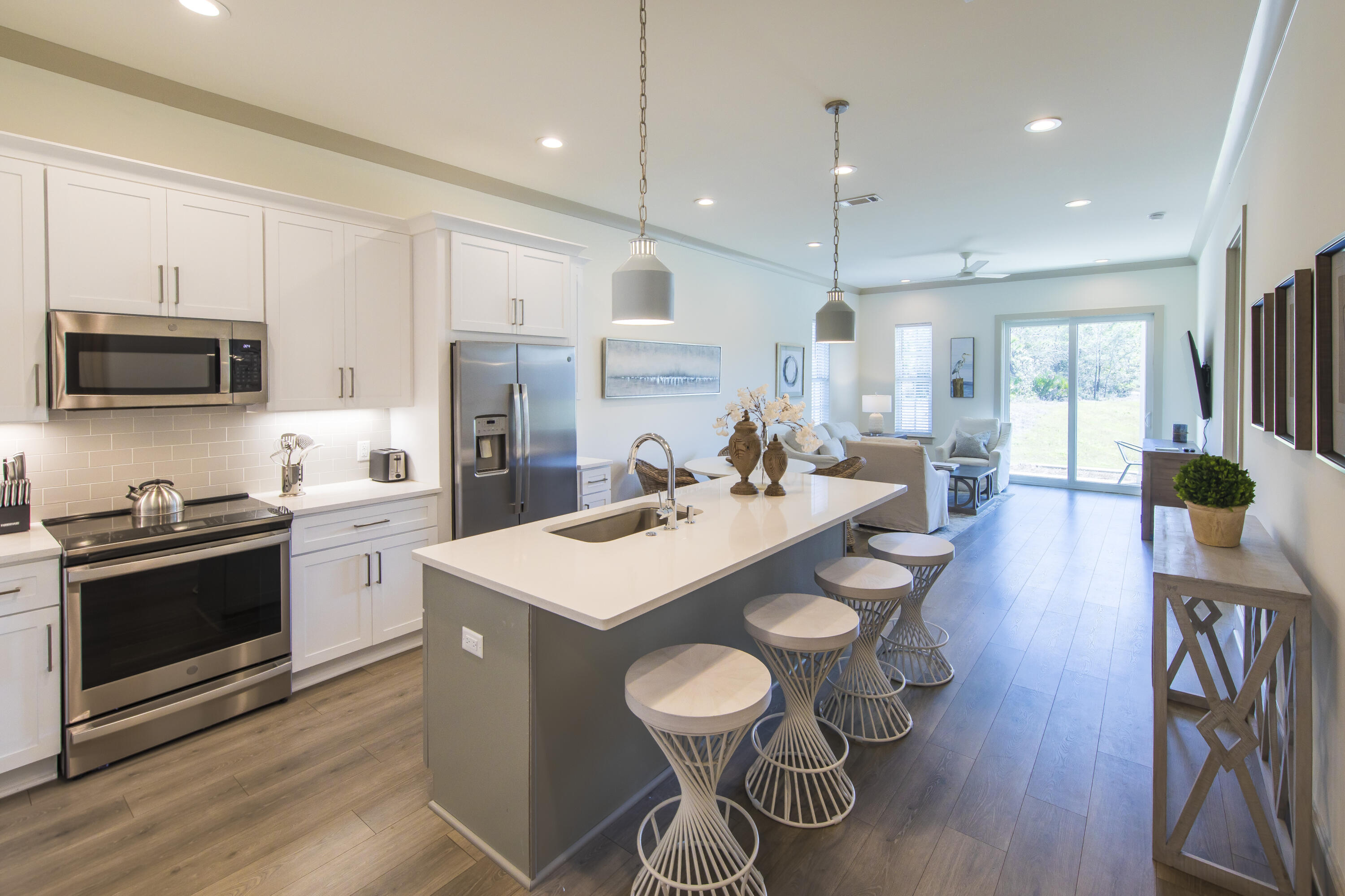 70 Marthas Lane, Unit 1201 Santa Rosa Beach, FL 32459 - Photo 10 of 28 a large kitchen with sink a stove a dining table and chairs