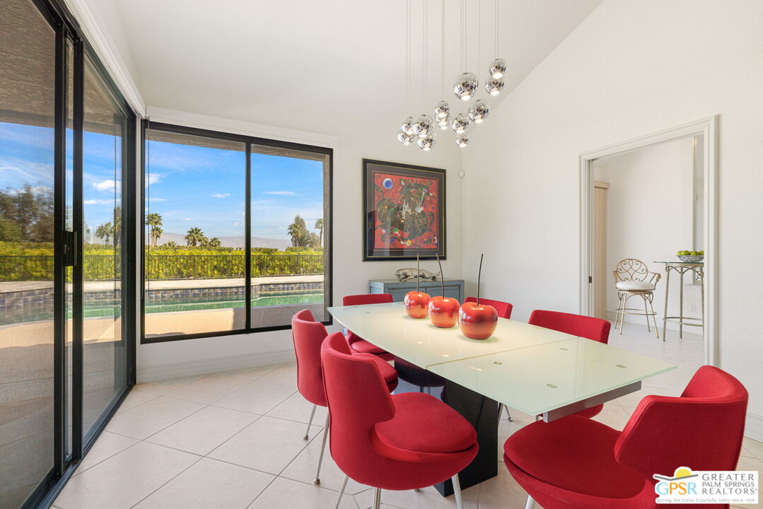 8 Alta Vista Rancho Mirage, CA 92270 - Photo 25 of 46 a view of a dining room with furniture a chandelier and a large window