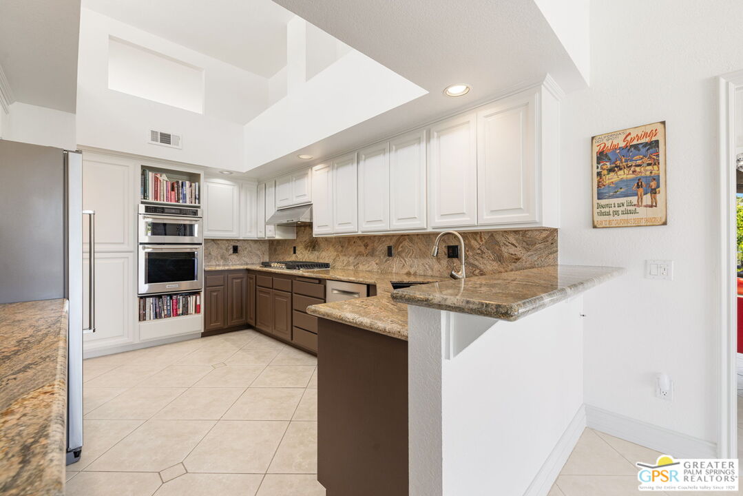 8 Alta Vista Rancho Mirage, CA 92270 - Photo 28 of 46 a kitchen with a sink a stove top oven and refrigerator