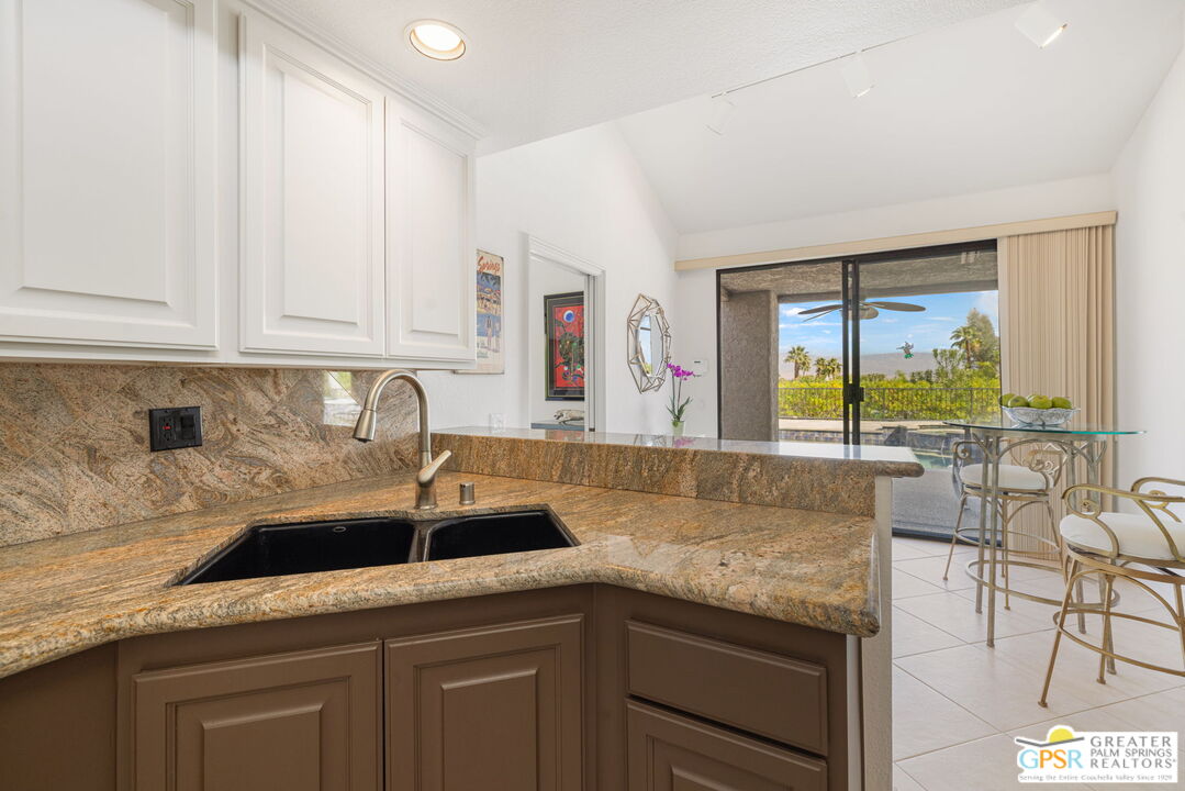 8 Alta Vista Rancho Mirage, CA 92270 - Photo 29 of 46 a kitchen with stainless steel appliances granite countertop a sink a stove and cabinets
