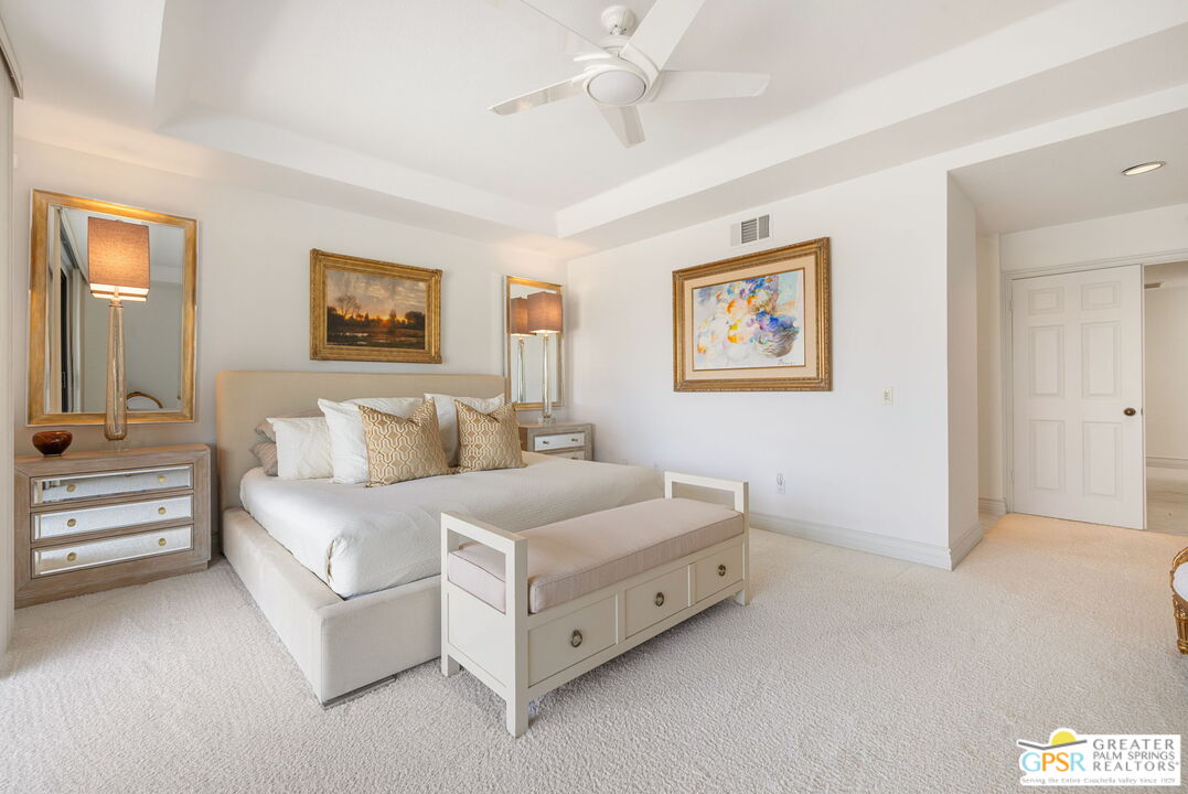 8 Alta Vista Rancho Mirage, CA 92270 - Photo 35 of 46 a spacious bedroom with a bed and a painting on the wall