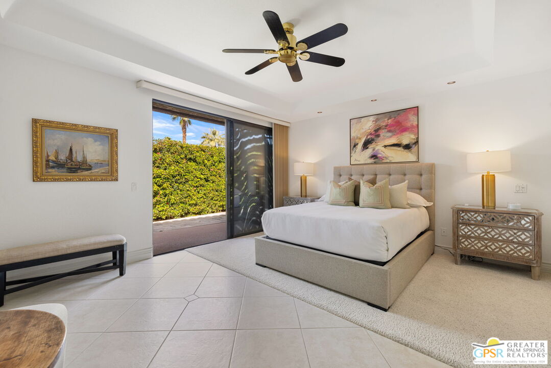 8 Alta Vista Rancho Mirage, CA 92270 - Photo 38 of 46 a bedroom with a bed a couch and a window