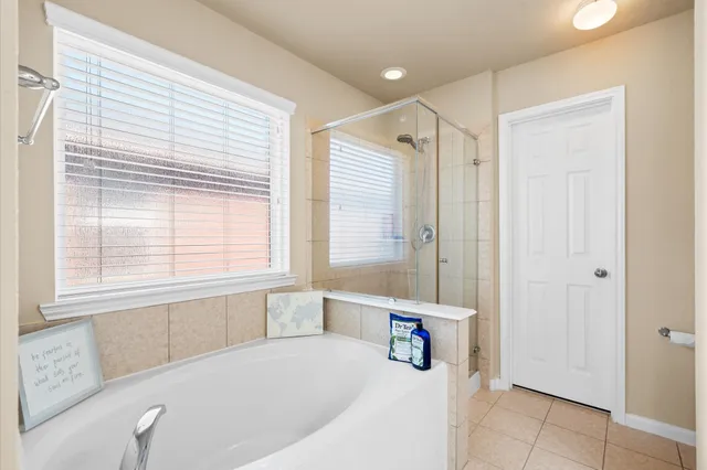 a bathroom with a bathtub and a shower