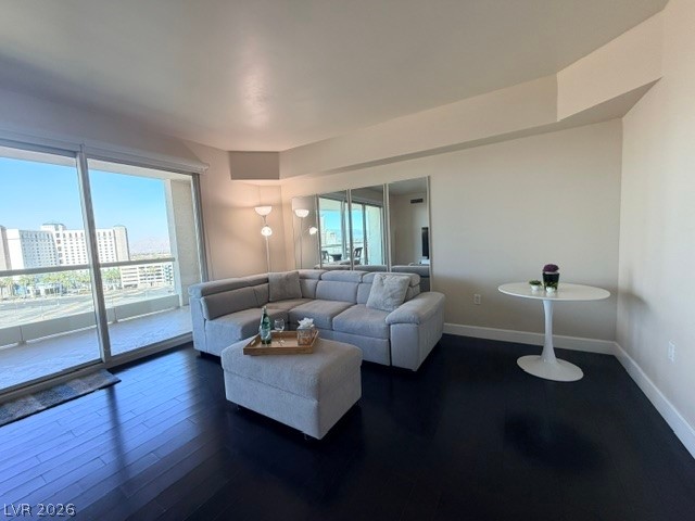 2777 Paradise Road, Unit 807 Las Vegas, NV 89109 - Photo 43 of 61 City views and a balcony complement this naturally illuminated living space with sleek dark wood flooring.