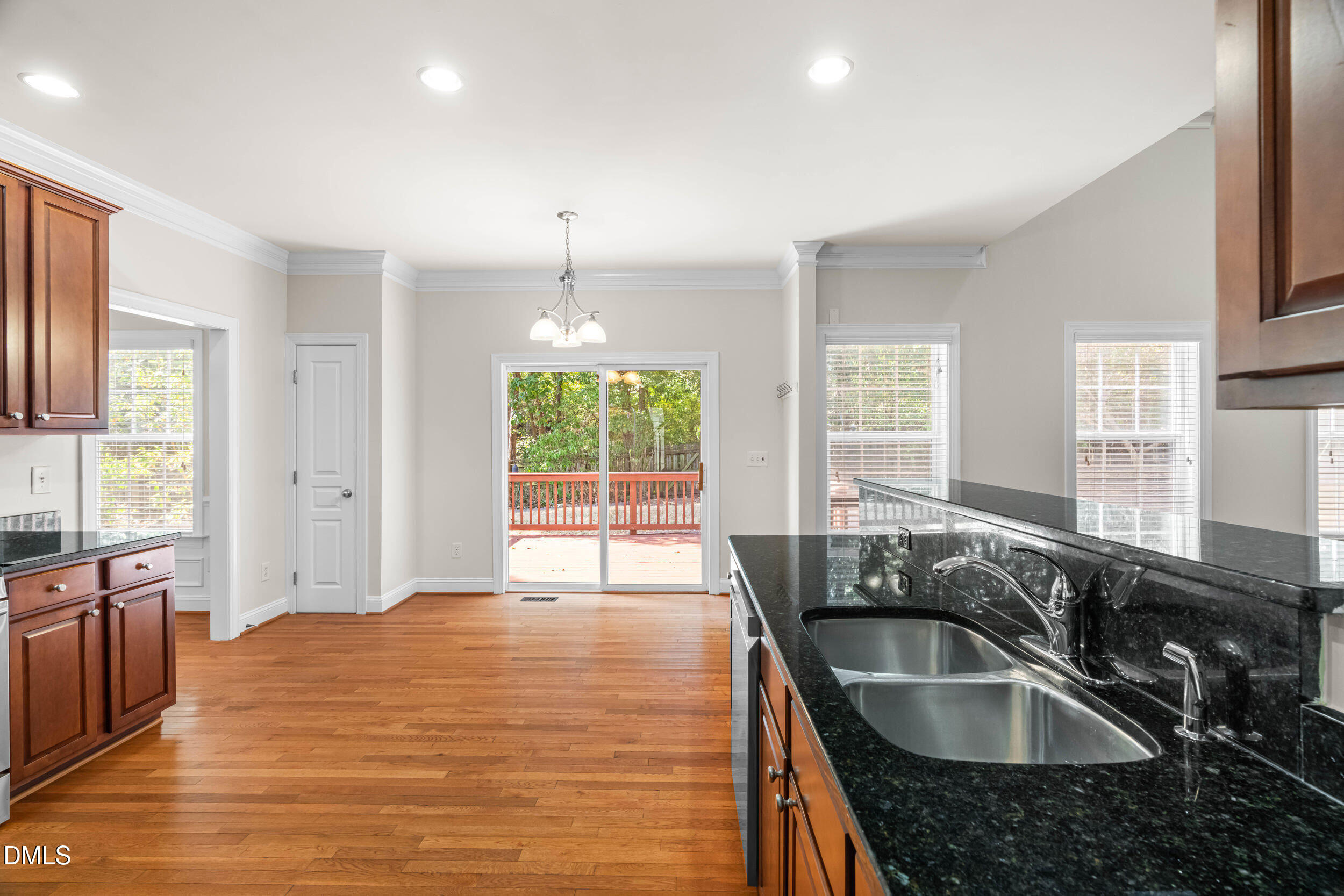 5708 Catskill Court Durham, NC 27713 - Photo 12 of 39 a large kitchen with granite countertop a large counter top space a sink a window and stainless steel appliances