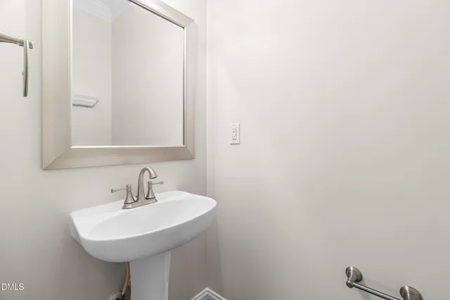 a bathroom with a sink a mirror and a toilet