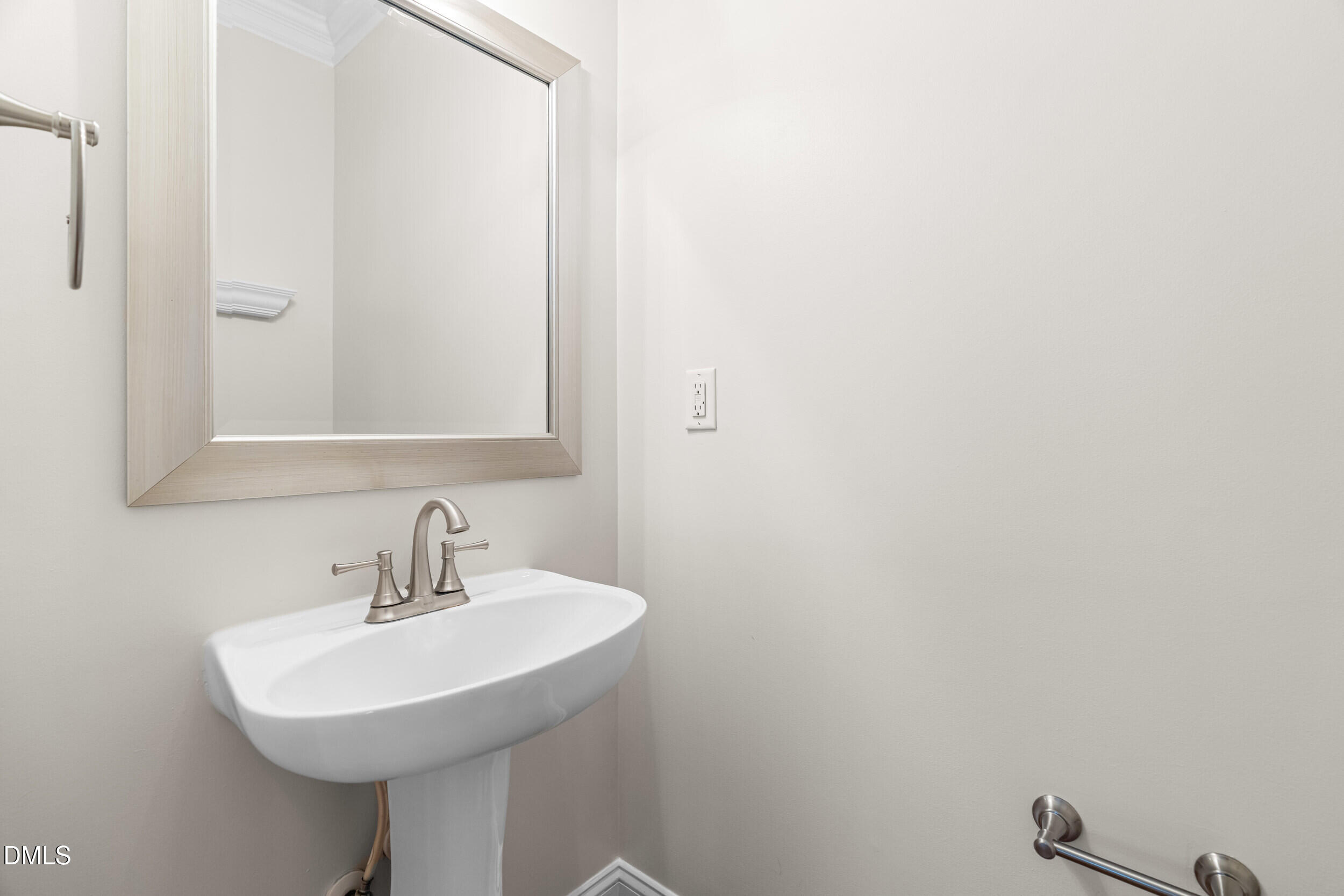 5708 Catskill Court Durham, NC 27713 - Photo 19 of 39 a bathroom with a sink a mirror and a toilet