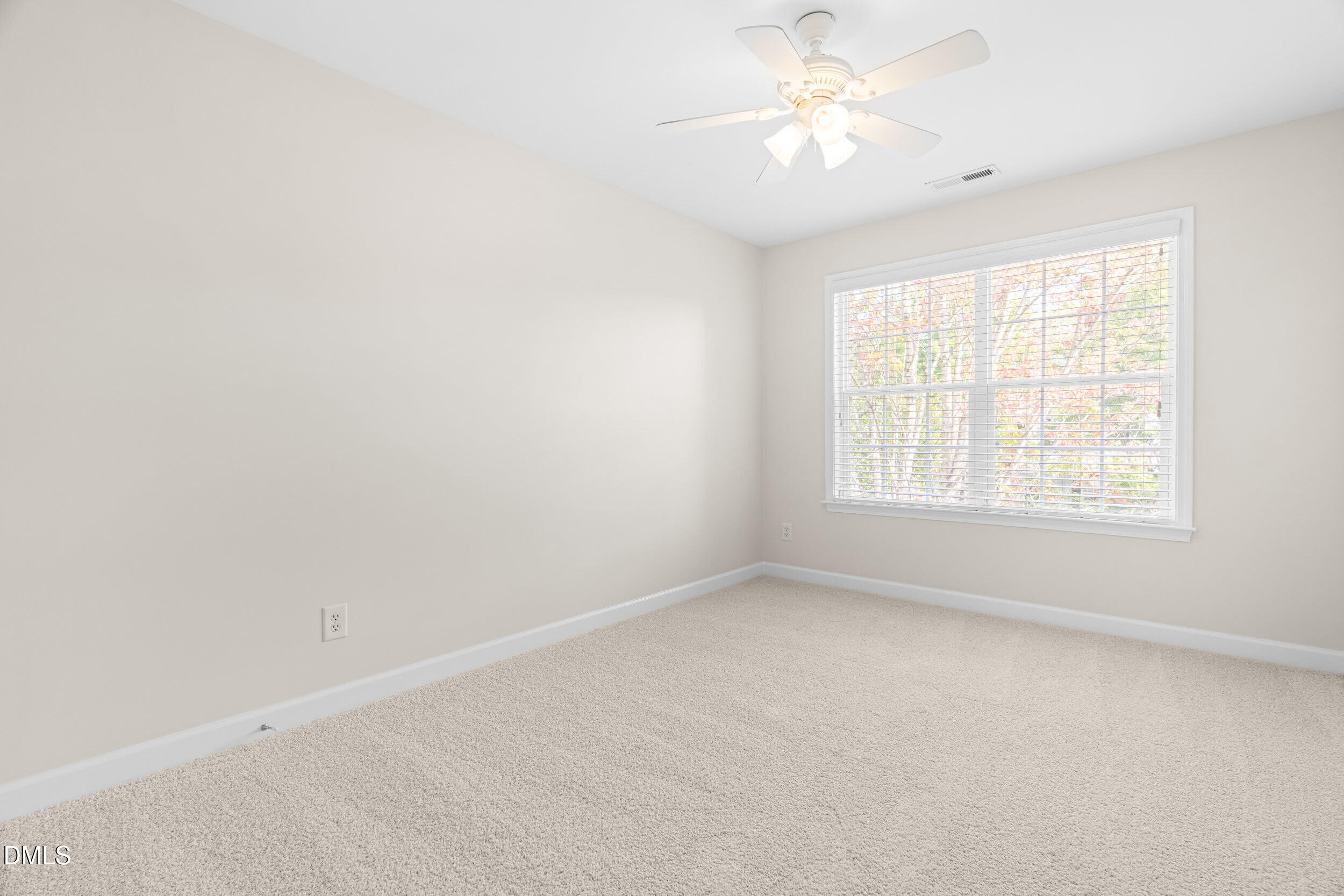 5708 Catskill Court Durham, NC 27713 - Photo 21 of 39 an empty room with a window and a fan