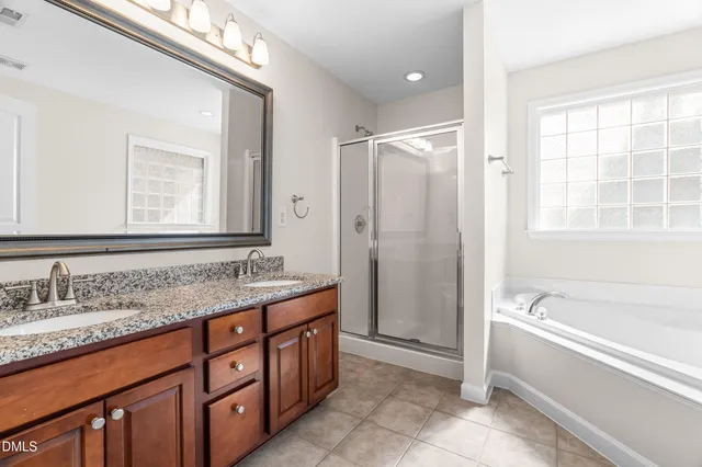 a bathroom with a tub a sink and a mirror