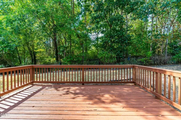 a view of balcony with wooden floor and fence