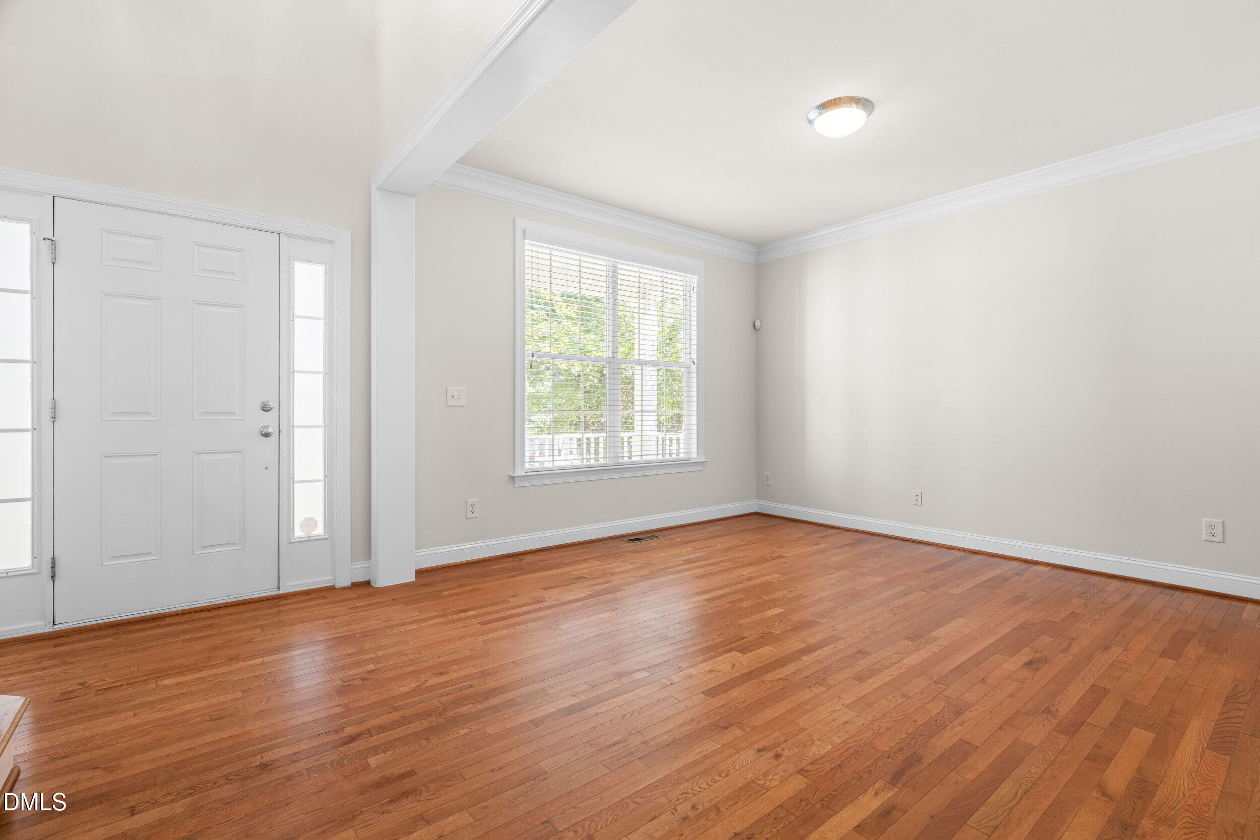 5708 Catskill Court Durham, NC 27713 - Photo 5 of 39 an empty room with wooden floor and windows