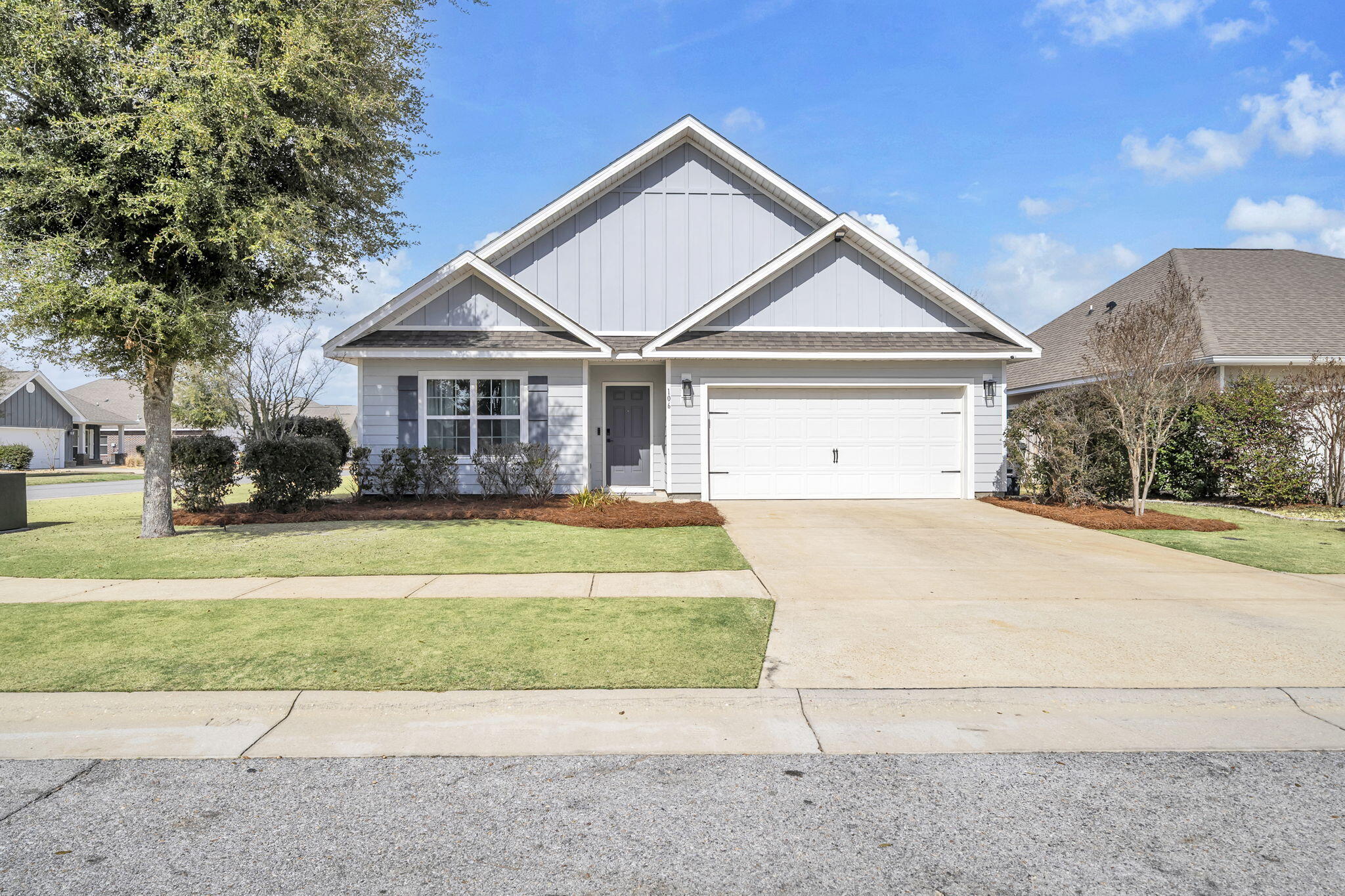 106 Mary Ellen Way Freeport, FL 32439 - Photo 1 of 79 a front view of a house with a garden and trees
