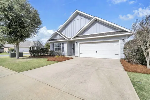a view of house with outdoor space and parking