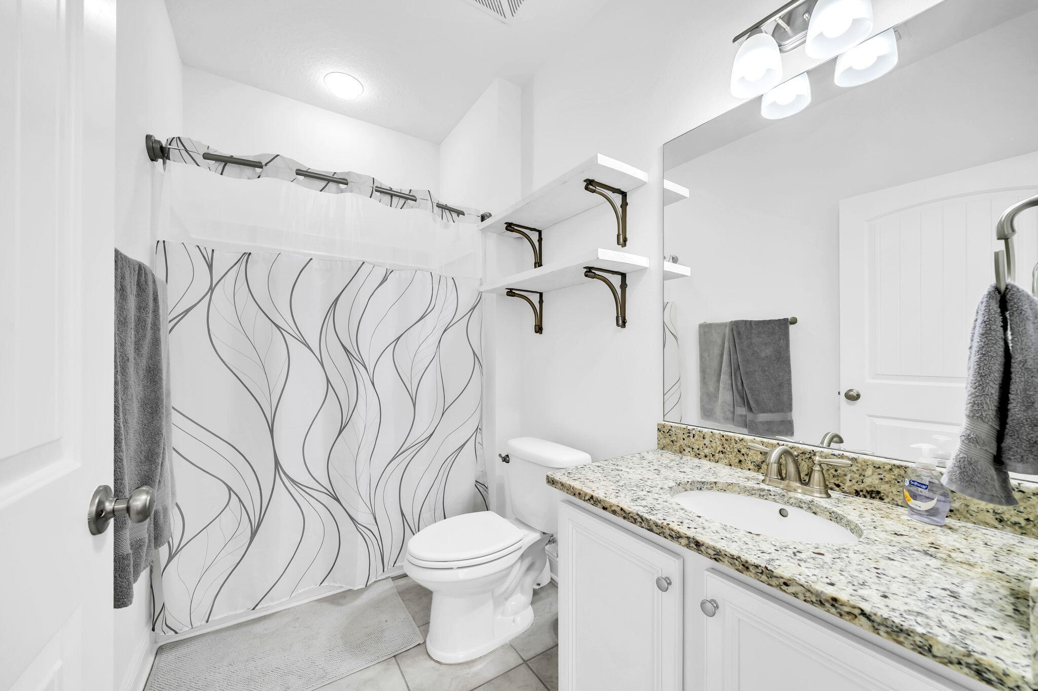 106 Mary Ellen Way Freeport, FL 32439 - Photo 30 of 79 a bathroom with a granite countertop sink a toilet and a mirror