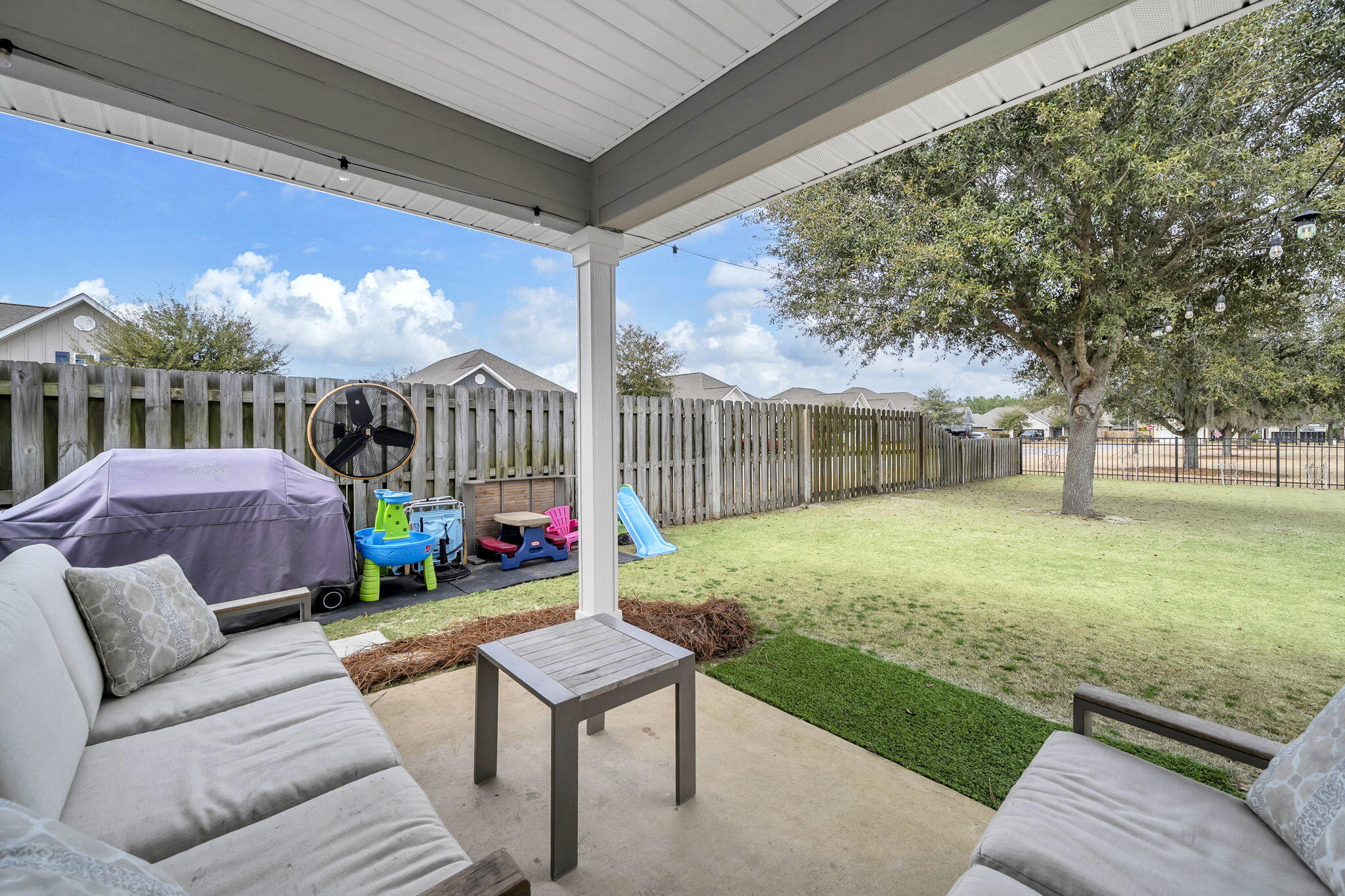 106 Mary Ellen Way Freeport, FL 32439 - Photo 38 of 79 a view of a patio with couches chairs and a yard