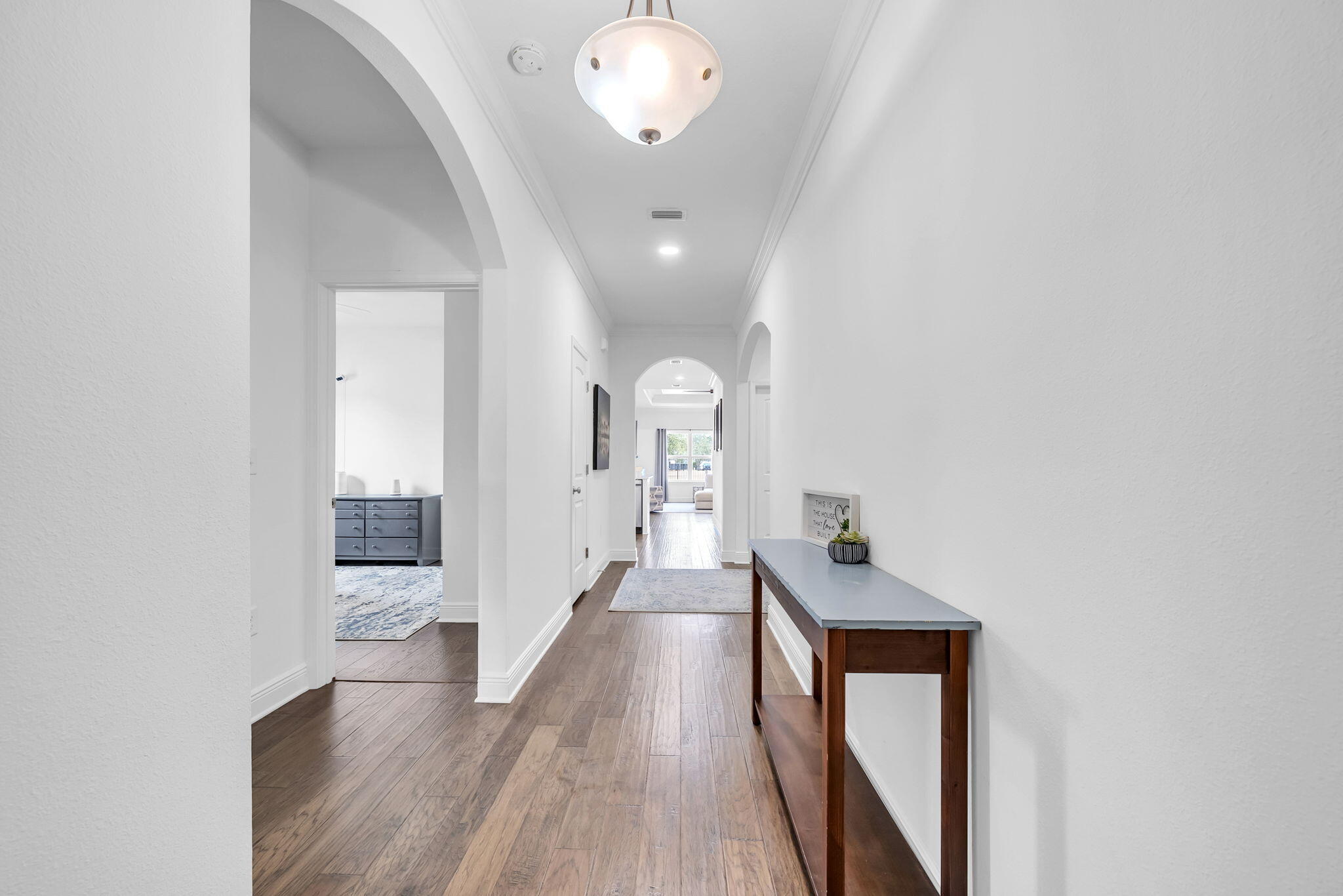 106 Mary Ellen Way Freeport, FL 32439 - Photo 7 of 79 a view of a hallway with wooden floor and a chandelier
