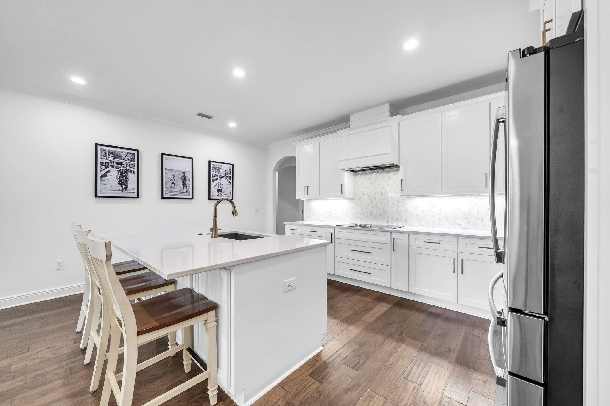 106 Mary Ellen Way Freeport, FL 32439 - Photo 10 of 79 a kitchen with white cabinets and stainless steel appliances