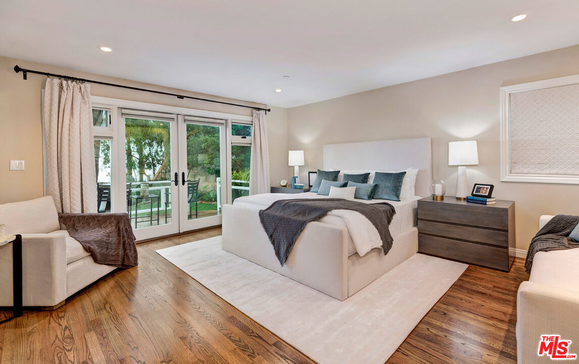 20779 Big Rock Drive Malibu, CA 90265 - Photo 15 of 37 a bedroom with a bed and glass window