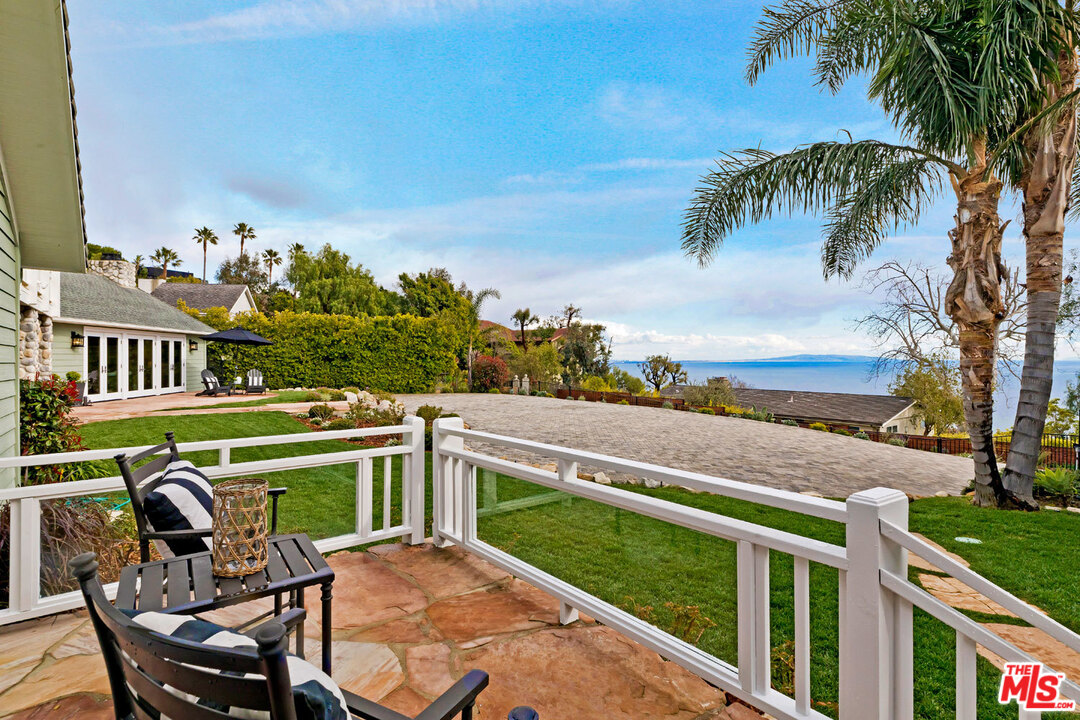 20779 Big Rock Drive Malibu, CA 90265 - Photo 16 of 37 a view of a chairs and table in patio with a yard
