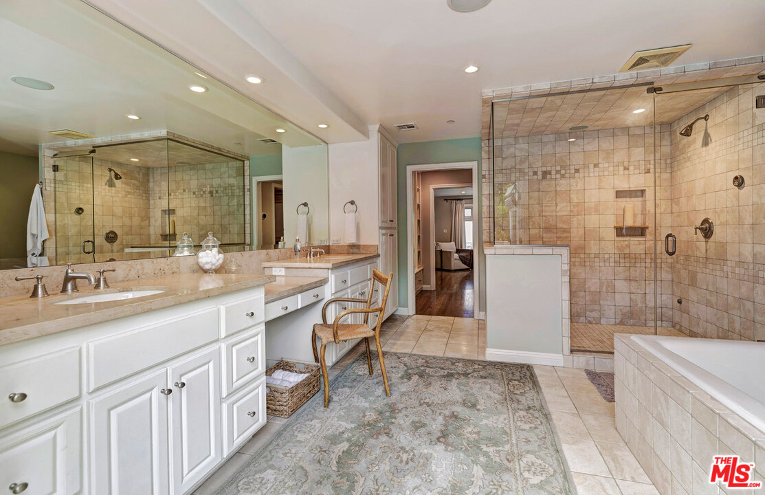 20779 Big Rock Drive Malibu, CA 90265 - Photo 19 of 37 a spacious bathroom with a shower a sink and a mirror