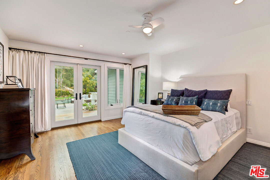 20779 Big Rock Drive Malibu, CA 90265 - Photo 24 of 37 a bedroom with bed and large window