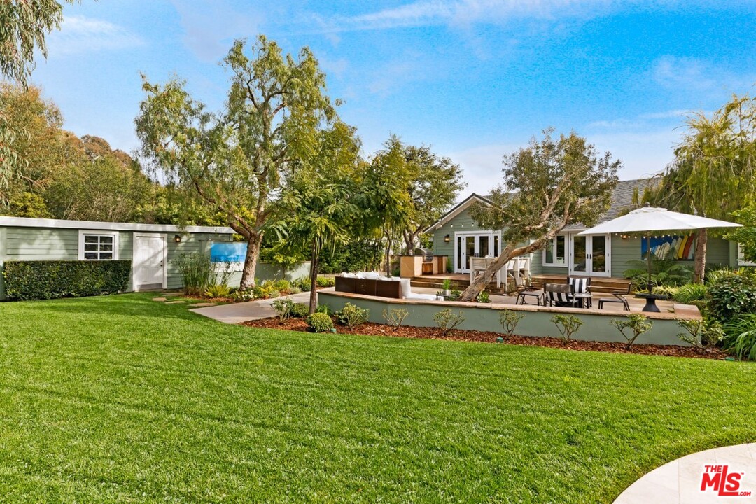 20779 Big Rock Drive Malibu, CA 90265 - Photo 33 of 37 a front view of a house with swimming pool having outdoor seating