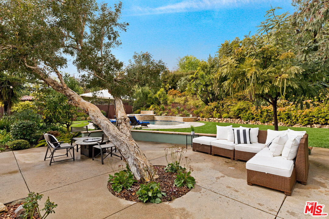 20779 Big Rock Drive Malibu, CA 90265 - Photo 35 of 37 a view of a patio with couches table and chairs and potted plants