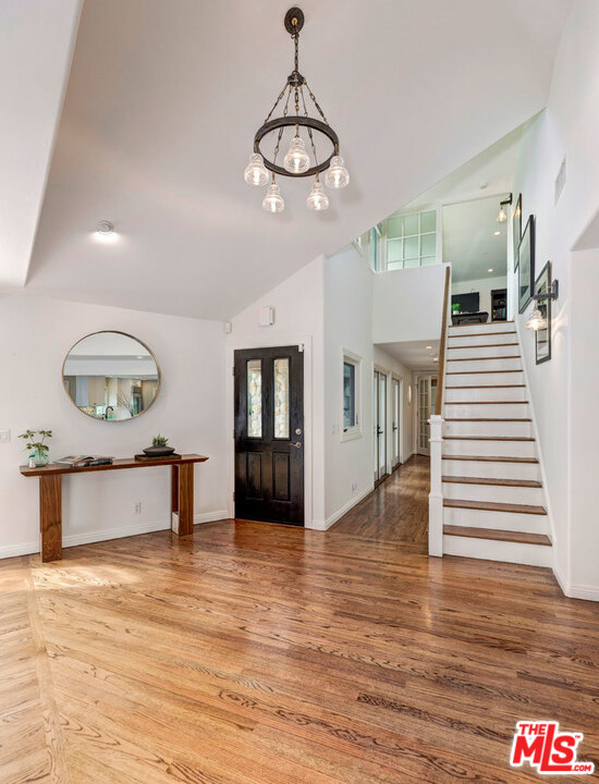 20779 Big Rock Drive Malibu, CA 90265 - Photo 6 of 37 a view of a living room and kitchen with wooden floor